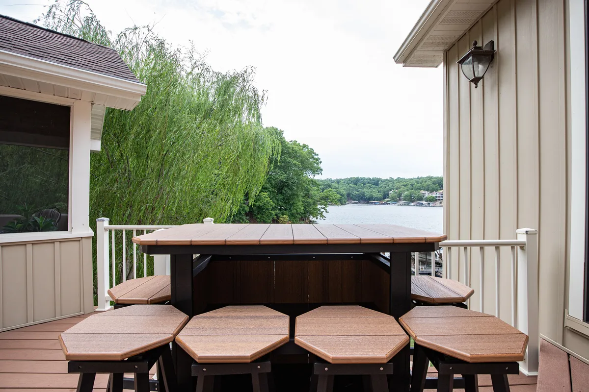 This image features a wooden picnic table set in a lush green area with a wide view of the lake. The setting invites outdoor dining, relaxation, and easy access to nature, all in a pet-friendly, open space.