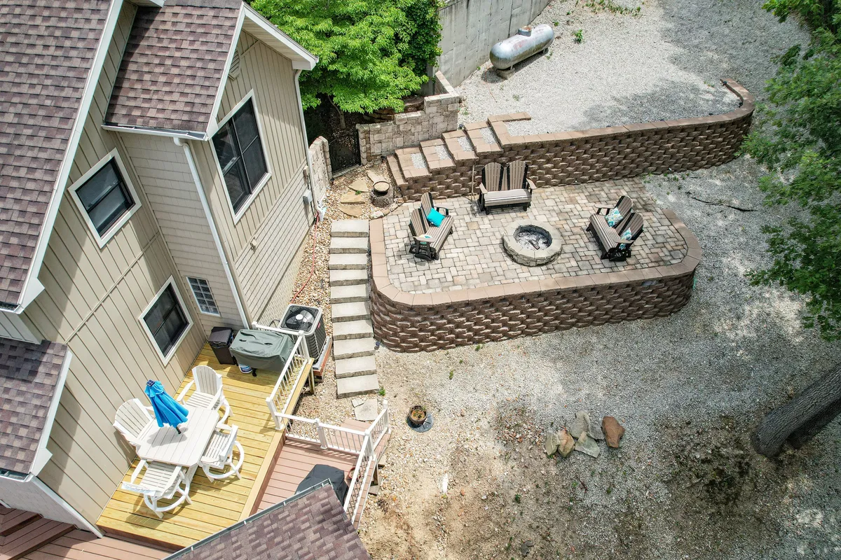 A well-appointed patio area with comfortable seating around a fire pit, landscaped steps, and an inviting atmosphere. It embodies spaces where guests can gather, relax, and enjoy convenient amenities without needing to bring extra supplies.